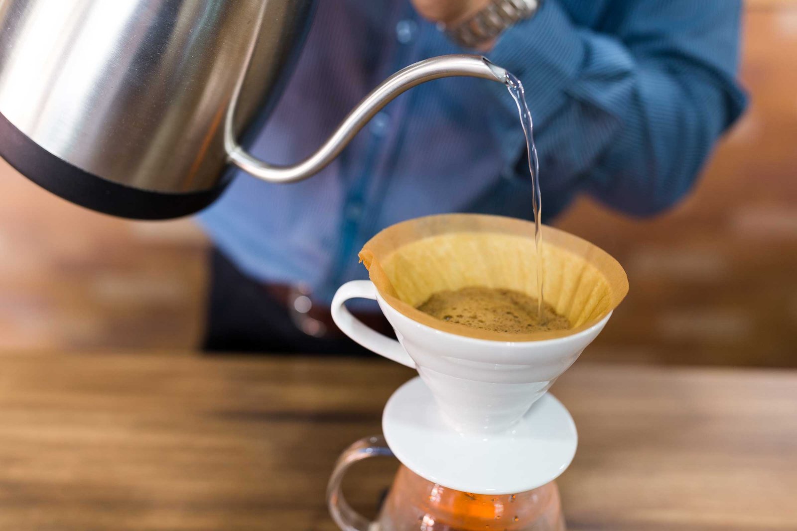 barista-pouring-water-on-coffee-with-filter-in-cof-2022-12-15-20-37-50-utc.jpg